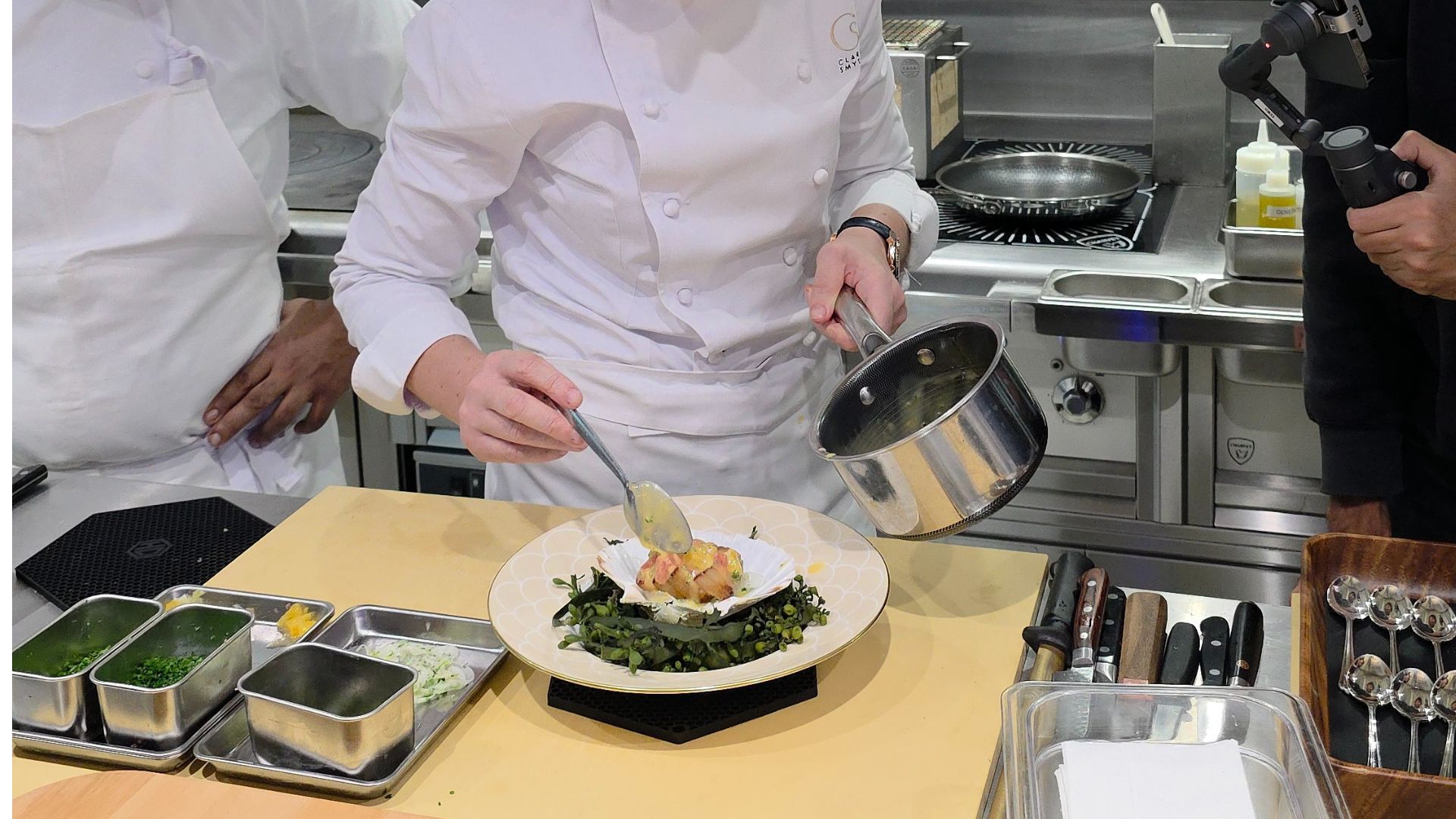 Clare Smyth Corenucopia adding sauce to a scallop