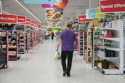 A man shops in a UK supermarket amid inflation crisis