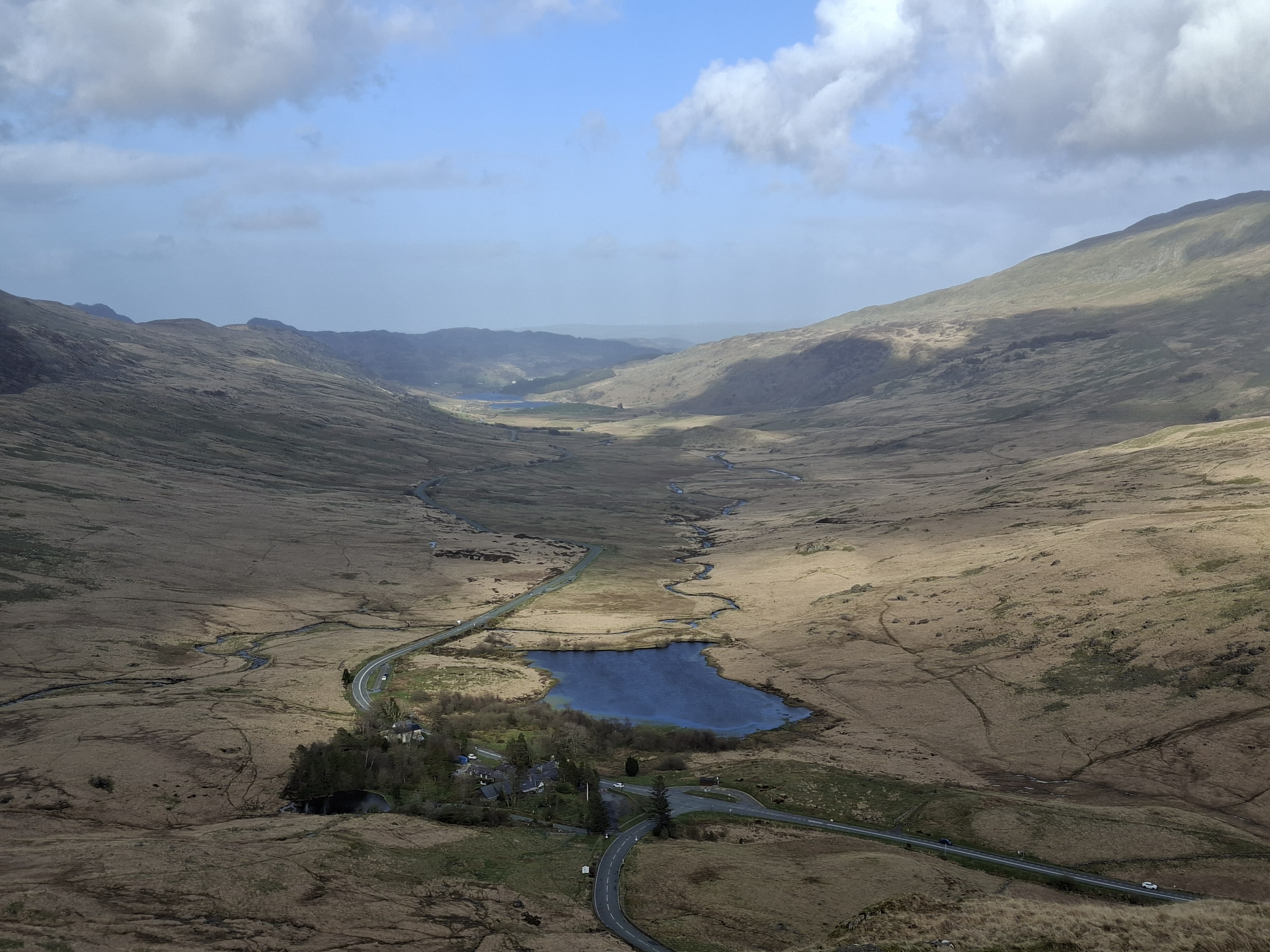 A photo taken on the Samsung Galaxy A57 showing a zoomed-in picture of some hills and a lake.