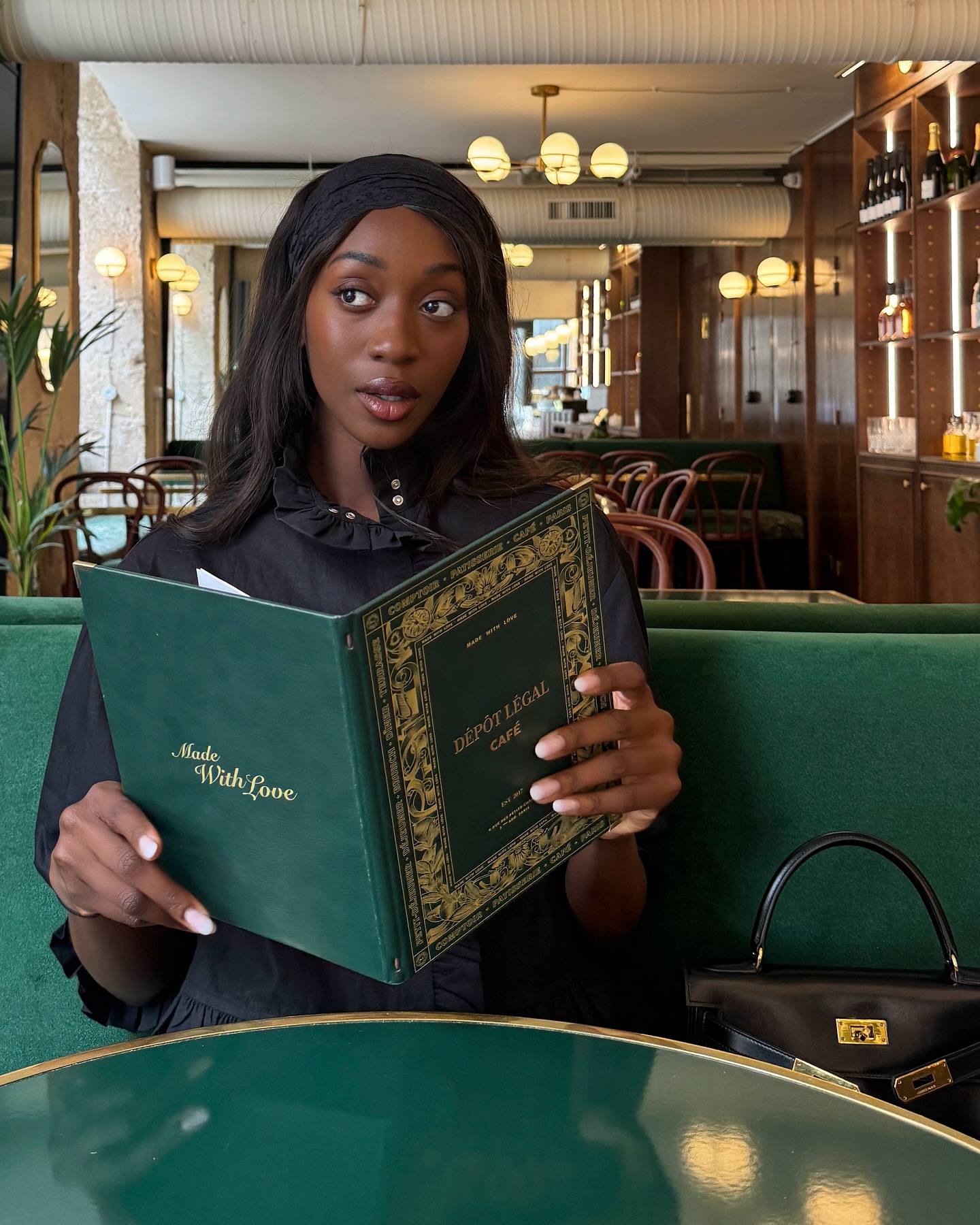Emmanuelle Koffi poses at a Parisian cafe