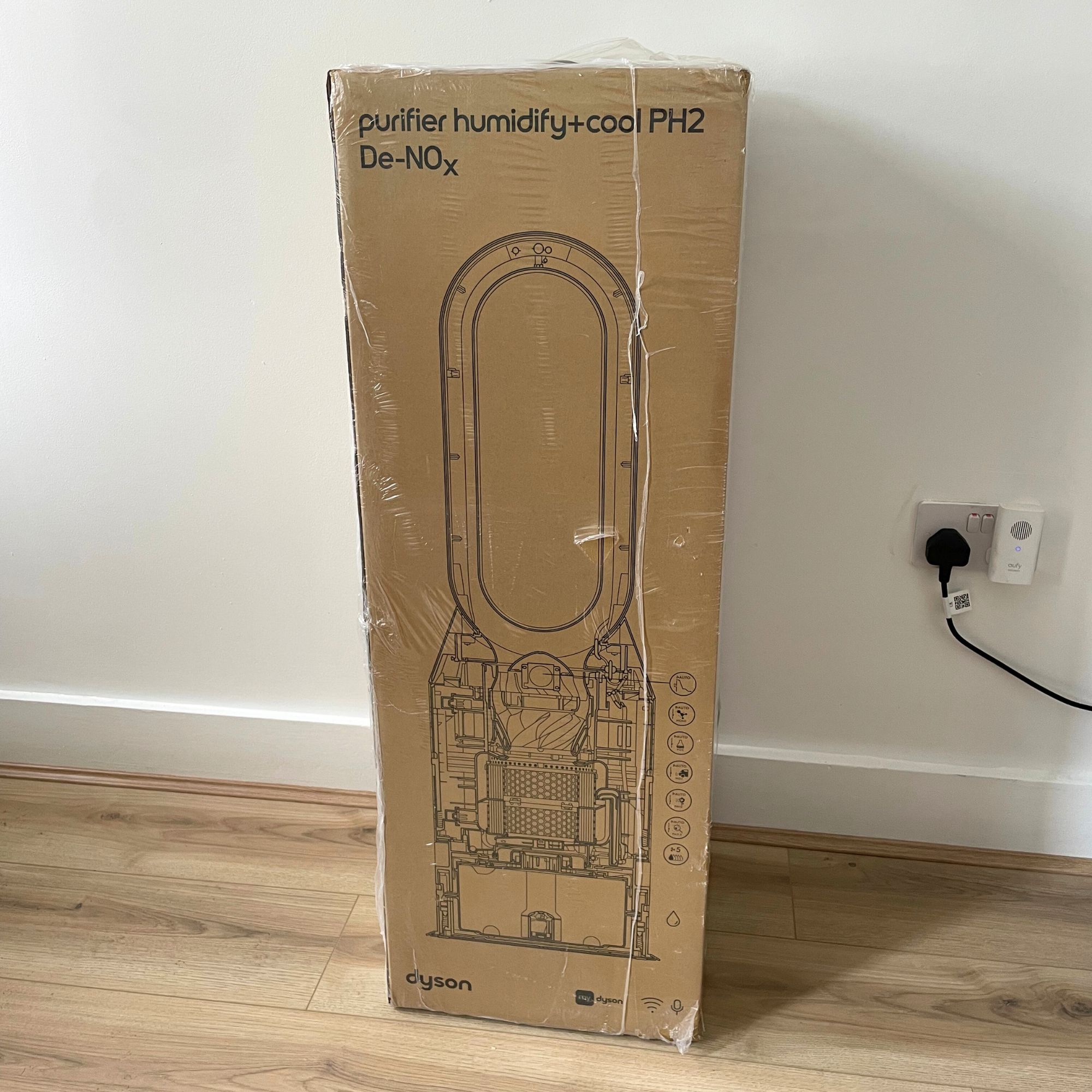 Dyson Purifier Humidify+Cool PH2 De-Nox in the box, sitting on wood effect flooring