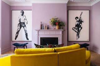 A living room with lavender walls and a yellow couch