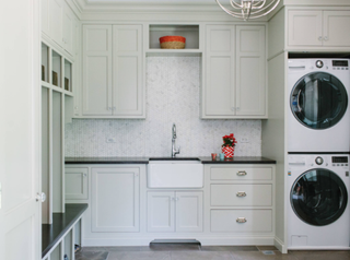 off white laundry room with granite countertop and white butler sink