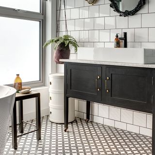 monochrome bathroom with black vintage mirror and white basin in black washstand