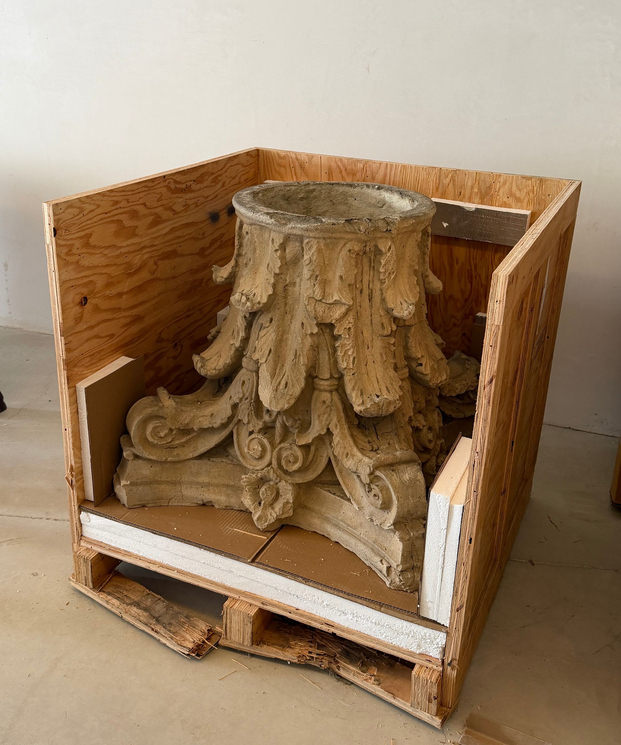 Large vintage stone sculpture sat in wooden crate