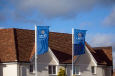 Flags at the entrance to a Crest Nicholson Holdings Plc new housing development in Tiptree, UK, on Thursday, Jan. 21, 2021. 