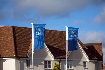 Flags at the entrance to a Crest Nicholson Holdings Plc new housing development in Tiptree, UK, on Thursday, Jan. 21, 2021. 