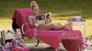 Elle Woods reading a magazine outside in Elle