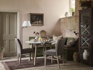 dining room area with bench seating, two chairs, round table and floor lamp