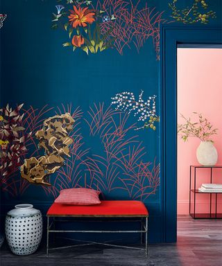 dark blue hallway with floral wallpaper mural and red bench