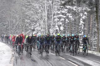 The peloton rides together as the snow falls on Paris-Nice.