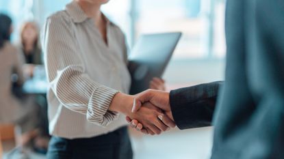 A stock photo of two businesspeople shaking hands. 