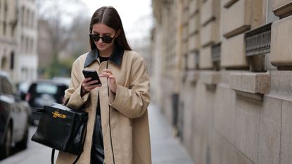 black friday hacks - woman checking her phone 1474403840