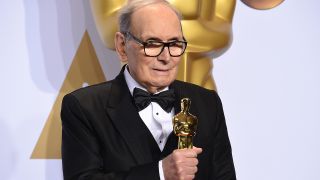 Ennio Morricone in 2016 with his Oscar for Best Original Score