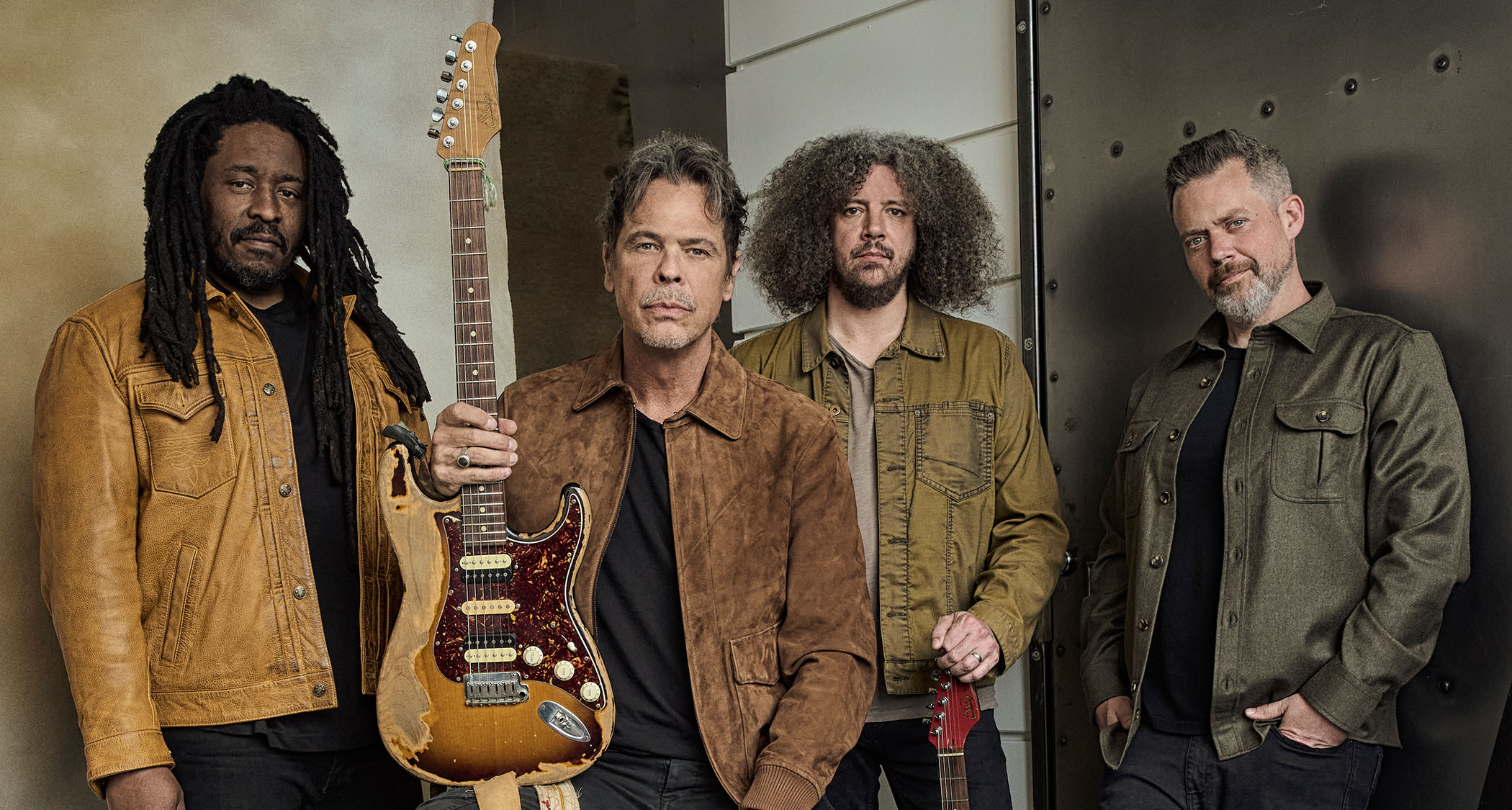 Big Wreck post for a band photo with Ian Thornley holding his Suhr electric guitar