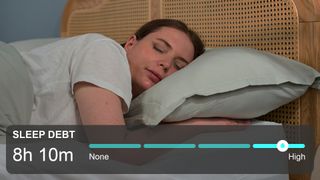 A woman with brown hair sleeps in her bed, while a sleep debt counter is seen below.