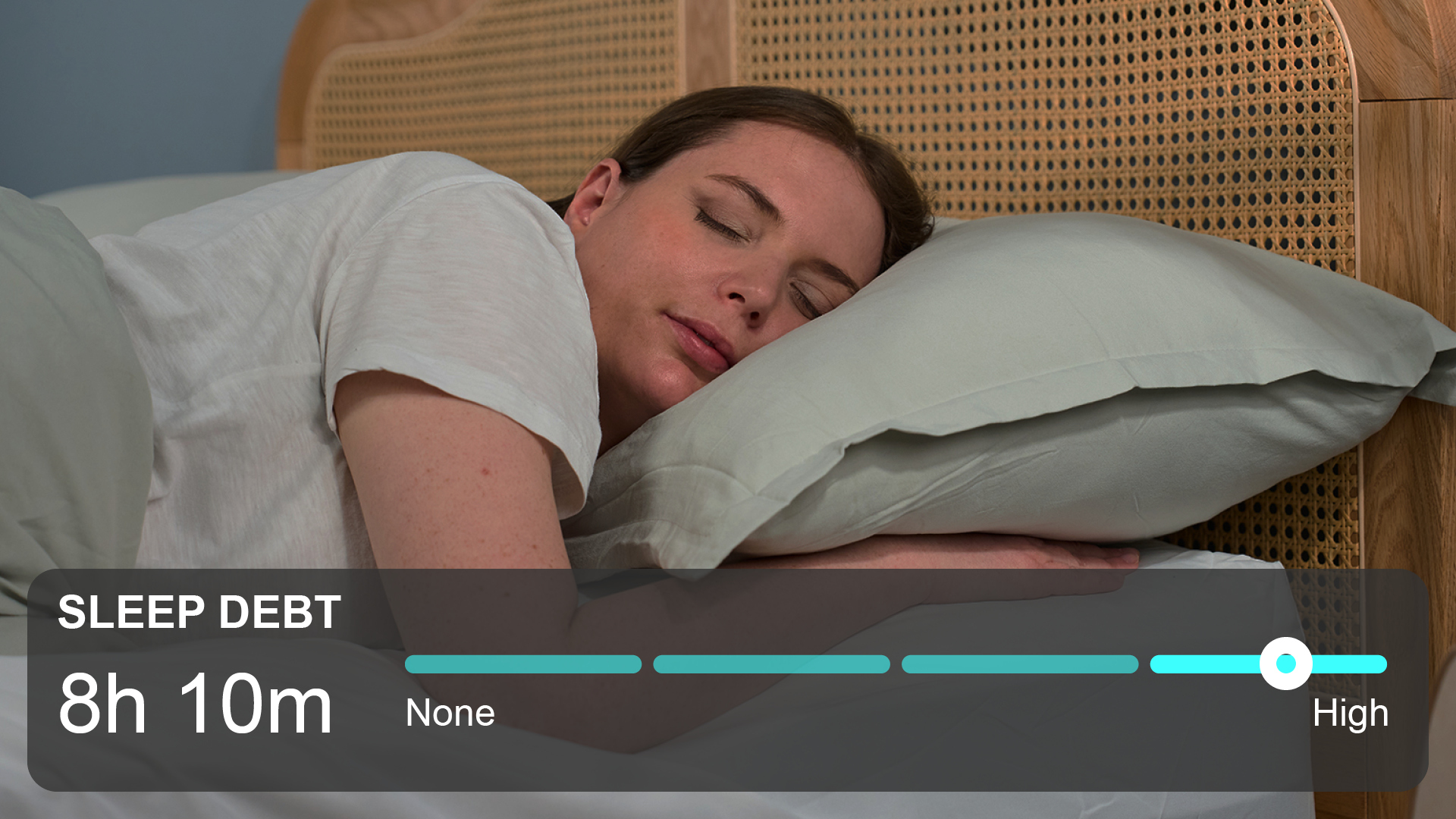 A woman with brown hair sleeps in her bed, while a sleep debt counter is seen below.