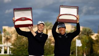 Jason and Bernhard Langer hold the PNC Championship belts above their head