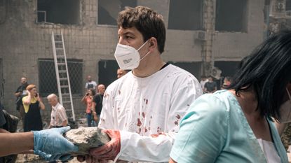Doctor helps clear rubble at Kyiv children's hospital destroyed in Russian strike