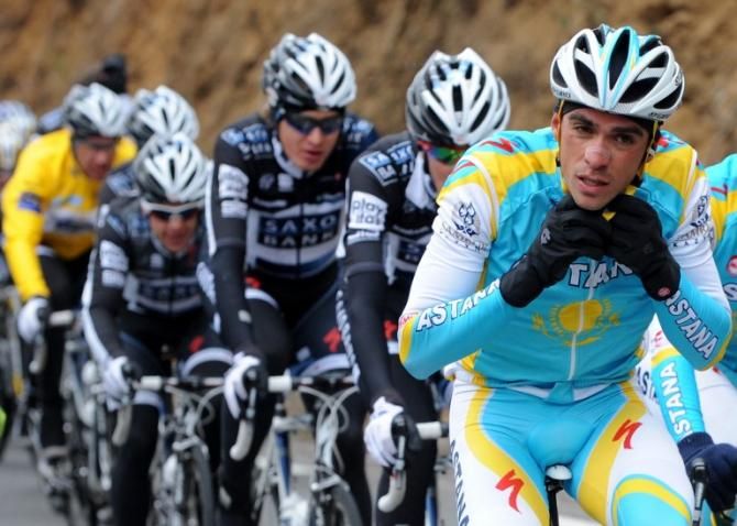 On the road to Mende in 2010 and Contador adjusts his helmet as SaxoBank watch on