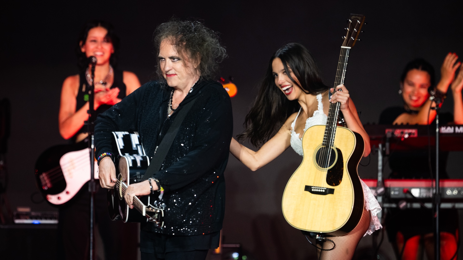 Olivia Rodrigo with Robert Smith of The Cure onstage at Glastonbury 2025