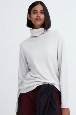 cold weather clothing - woman wearing turtleneck fleece long sleeve top
