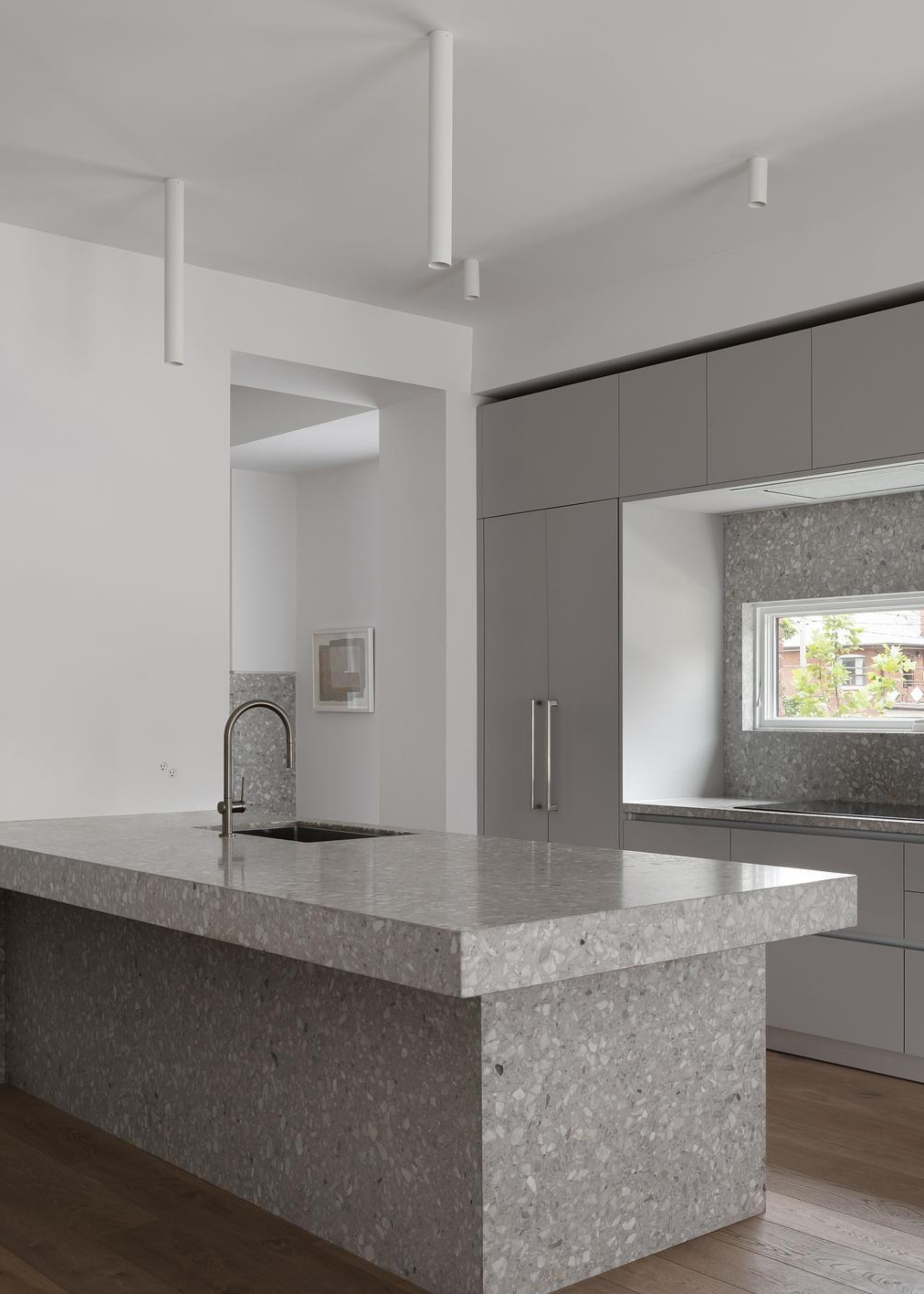 neutral kitchen with gray cabinets and a terrazzo counter