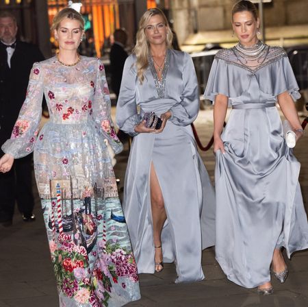 Kitty, Amelia and Eliza Spencer wearing blue evening gowns walking outside at night