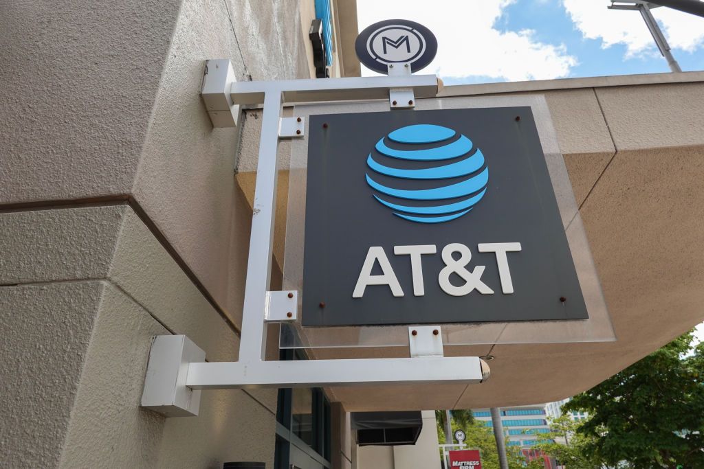 An AT&amp;T sign hanging outside a store.