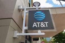 An AT&T sign hanging outside a store.