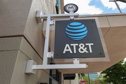An AT&T sign hanging outside a store.