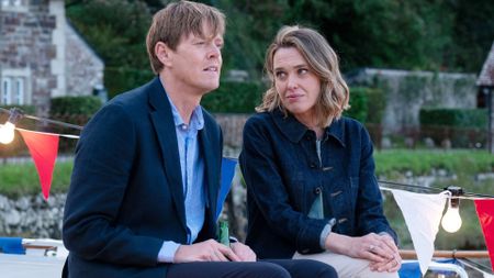 Martha looks at Humphrey as they sit on an outdoor table
