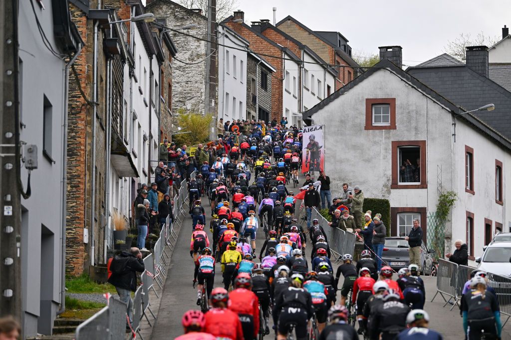 LIEGE BELGIUM APRIL 24 A general view of the peloton climbing to the Cte de SaintRoch 456m while fans cheer during the 8th Liege Bastogne Liege Femmes 2024 a 1529km one day race from Bastogne to Liege UCIWWT on April 24 2024 in Liege Belgium Photo by Luc ClaessenGetty Images
