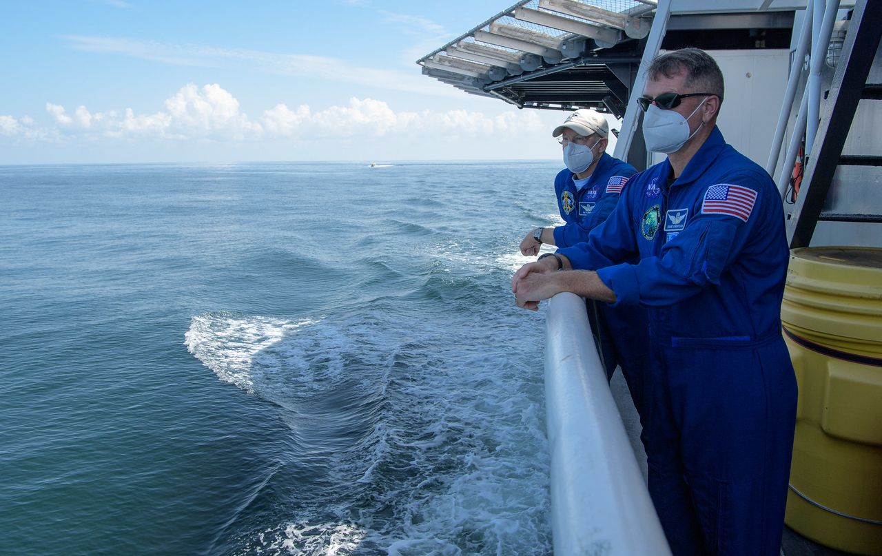 NASA Chief Astronaut Pat Forrester, left, and NASA astronaut and Crew Recovery Chief Shane Kimbrough, along with other NASA and SpaceX support teams onboard the SpaceX GO Navigator recovery ship, prepare for the landing of the SpaceX Crew Dragon Endeavour spacecraft with NASA astronauts Robert Behnken and Douglas Hurley onboard, Sunday, Aug. 2, 2020 in the Gulf of Mexico off the cost of Pensacola, Florida.