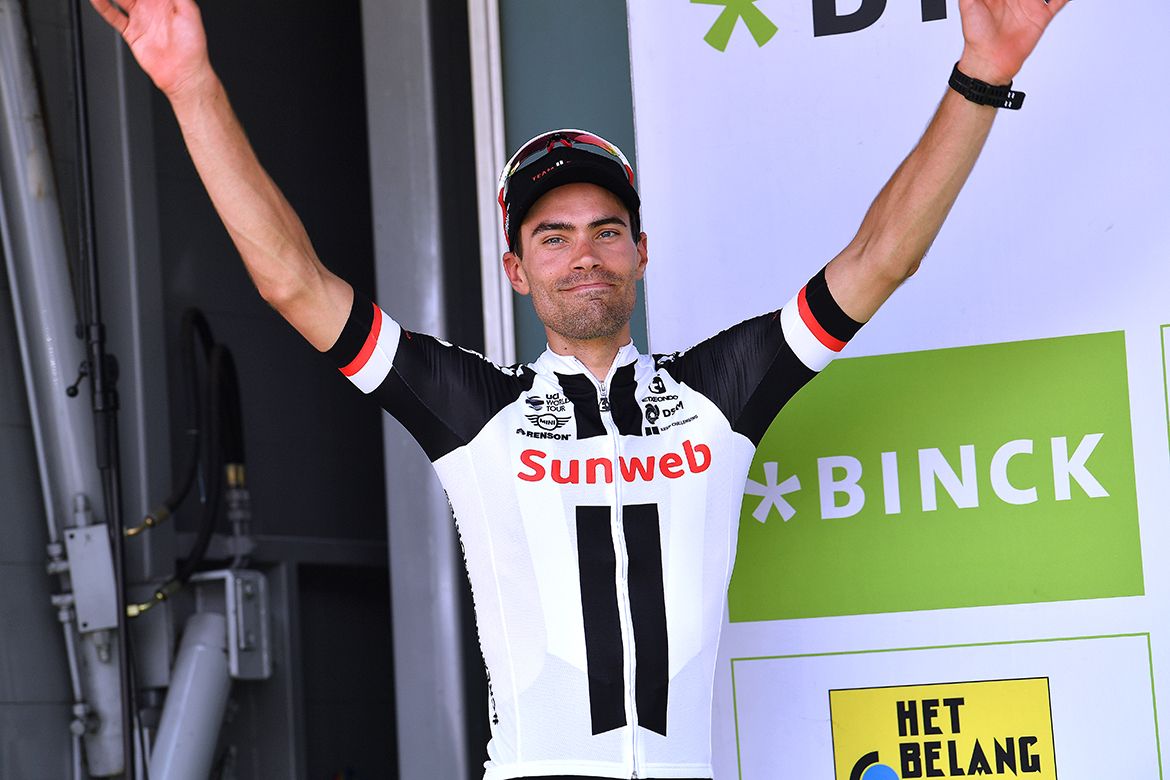 Tom Dumoulin takes the BinckBank Tour podium to receive his jersey and trophy.