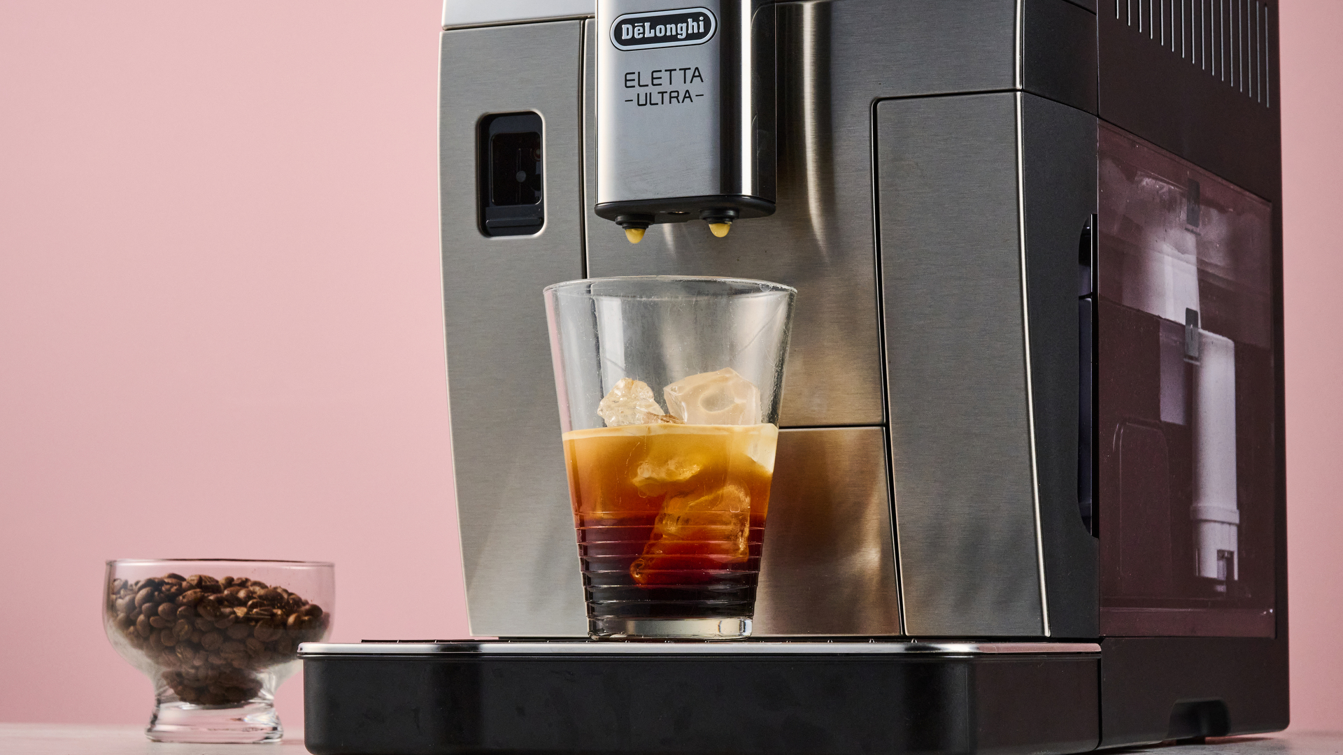 The De'Longhi Eletta Ultra cold extracting a glass of cold brew over ice.