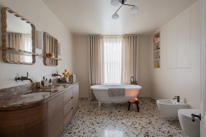 White bathroom with terrazzo floor and hidden wall storage