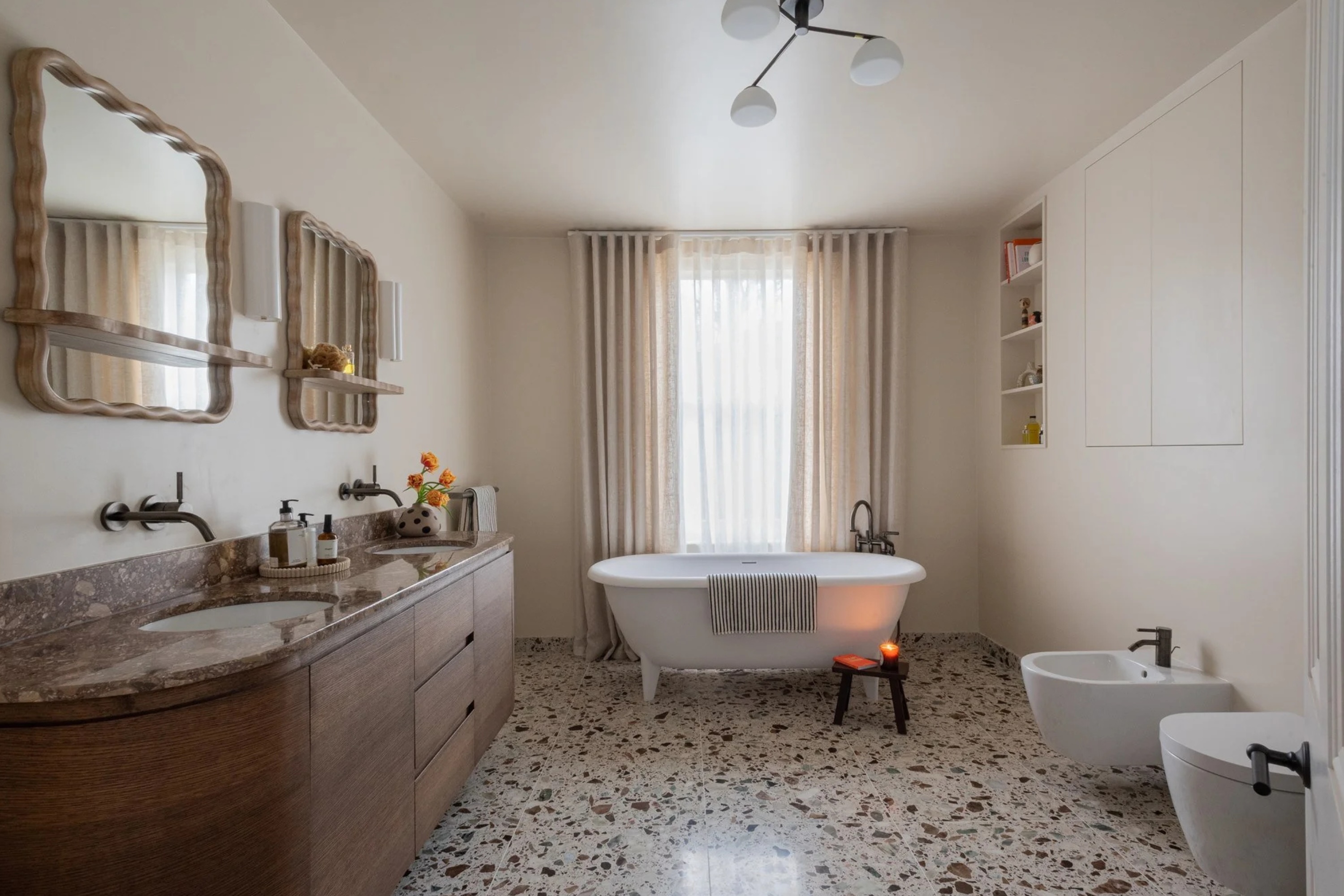 White bathroom with terrazzo floor and hidden wall storage
