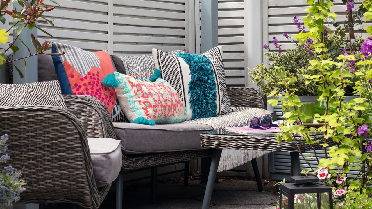 Grey outdoor sofa with red and blue cushions