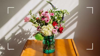 Glass vase of flowers sitting on a side table with sunshine casting a shadow, representing comforting loss of parents quotes