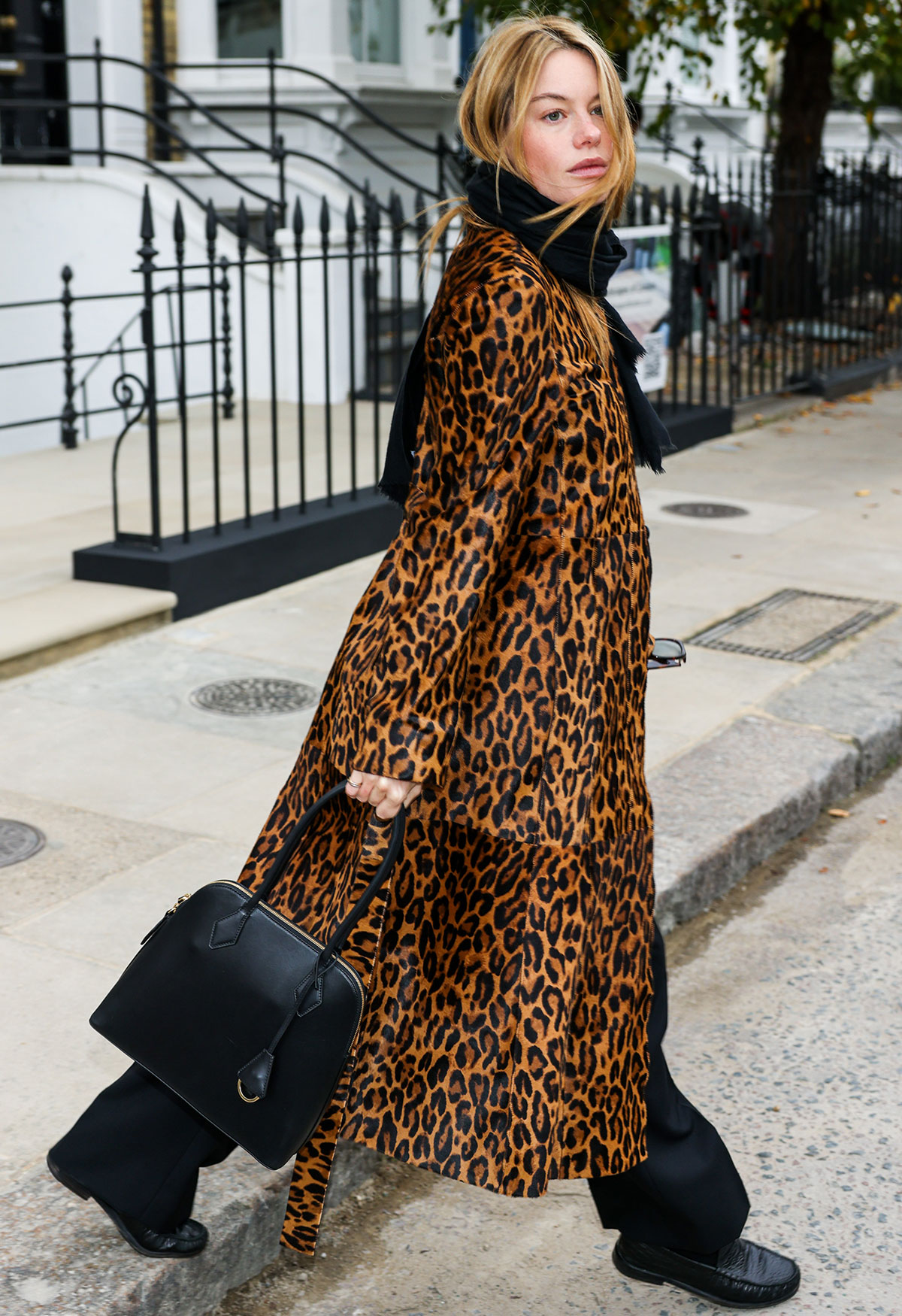 Woman wearing the animal-print coat trend of fall/winter 2025.