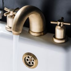 white washbasin with brass tap