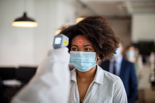 Monkeypox virus infection: A woman having her temperature taken