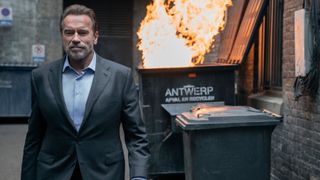 Luke Brunner (Arnold Schwarzenegger) walks away from a dumpster fire in FUBAR