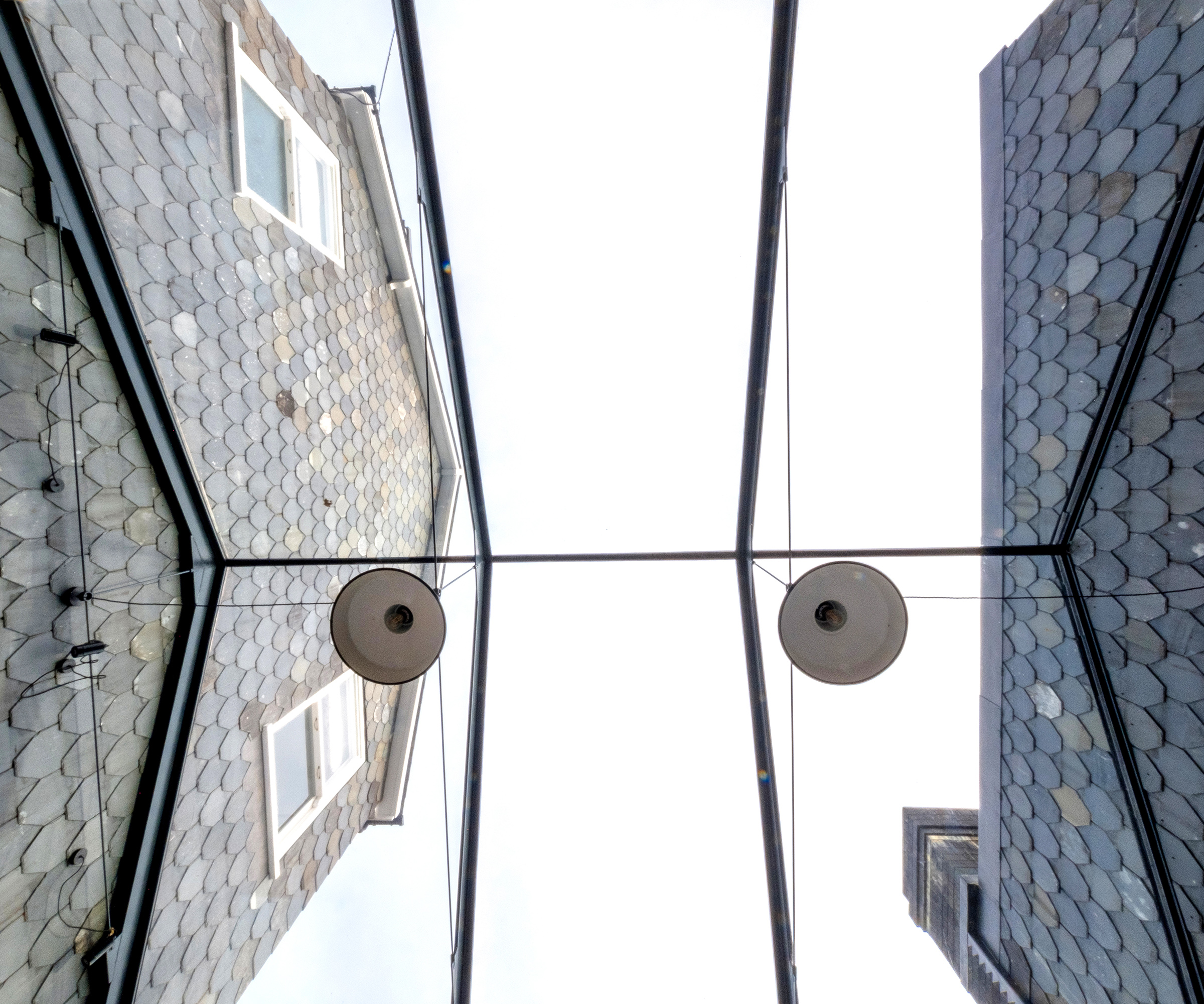 Pitched glass roof over a side extension