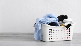 A laundry basket filled with dirty laundry