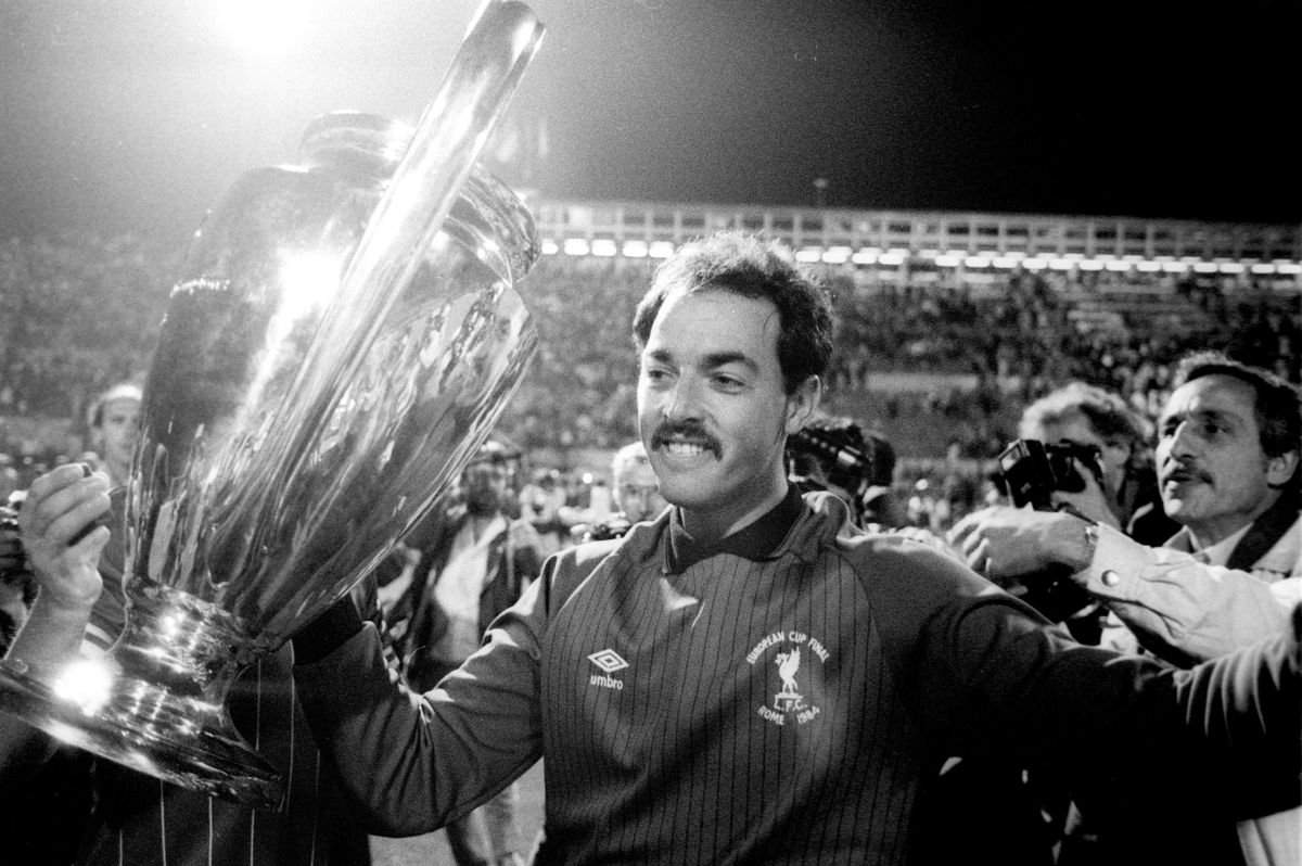 Liverpool goalkeeper Bruce Grobbelaar celebrates with the European Cup after helping his side to victory on penalties against Roma in the 1984 final