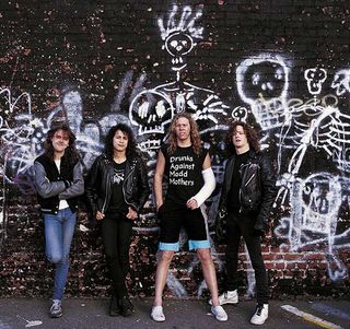 Metallica in 1987 standing against a wall