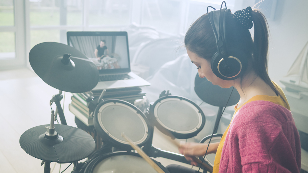 Girl taking an online drum lesson