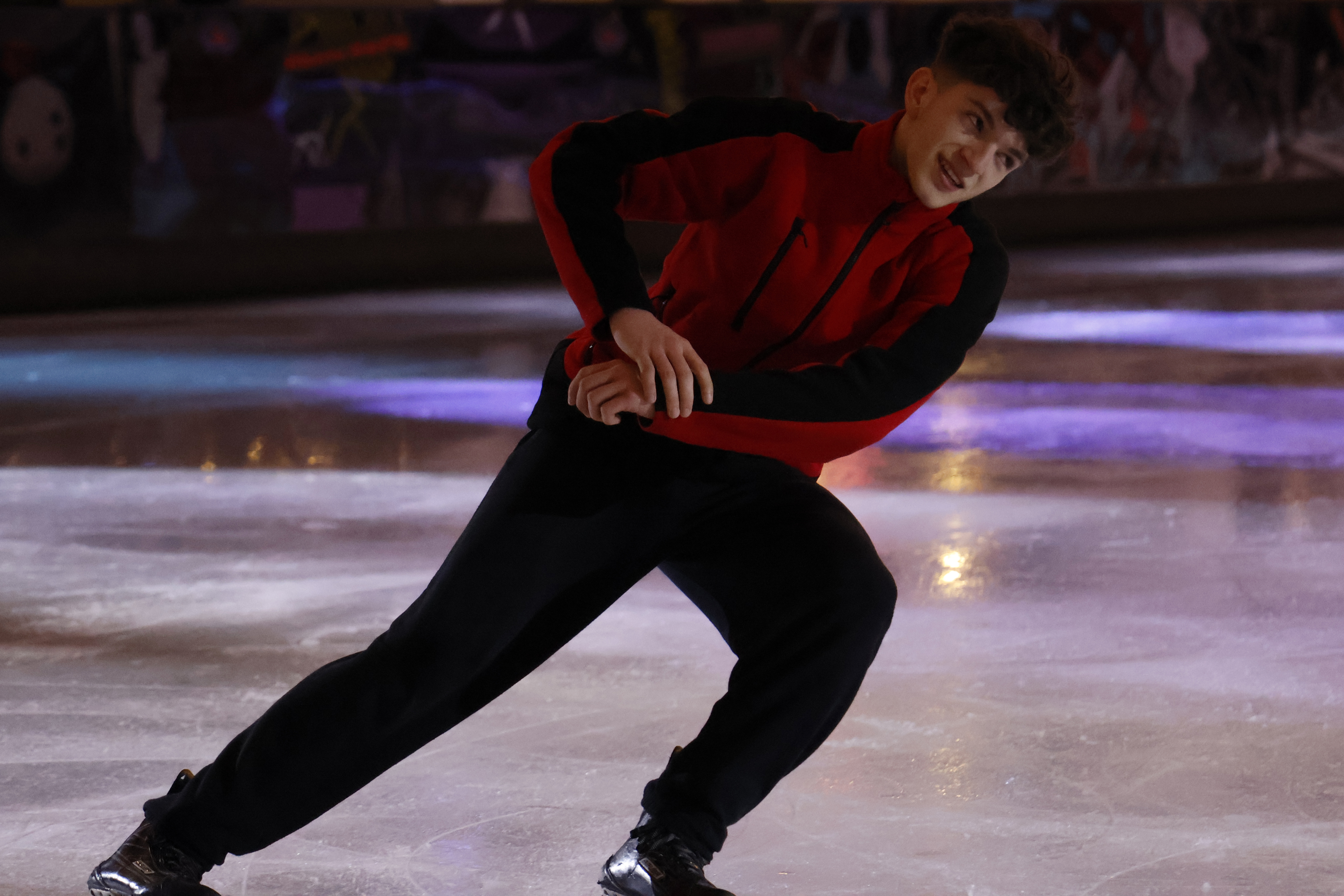 An ice skater performing at an ice rink